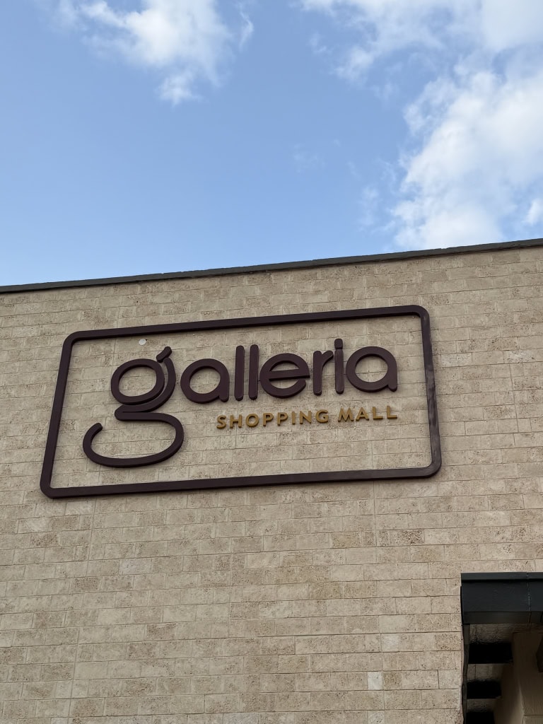 Galleria Shopping Mall logo mounted on a textured stone wall