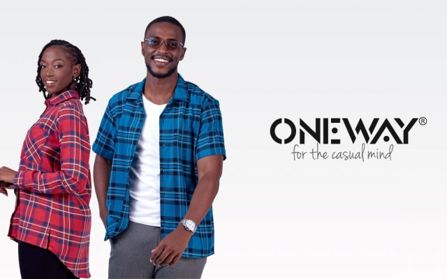 Promotional fashion artwork showing a woman and man wearing plaid clothing beside the ONE WAY logo.