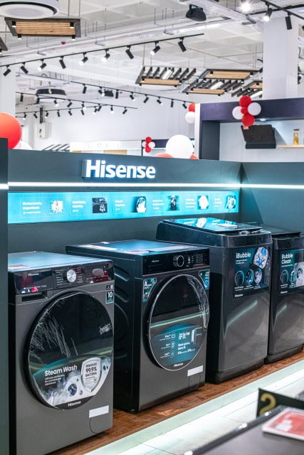 Hisense washing machines and dryers arranged in a store display