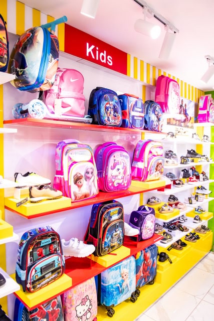 Colorful children’s section displaying character backpacks, shoes, and accessories