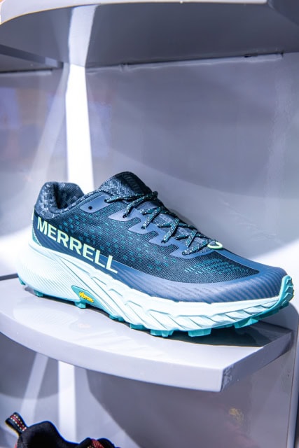Blue Merrell running shoe displayed on a white shelf