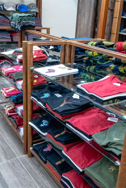 Retail interior with glass display cases and shelves of folded colorful clothing