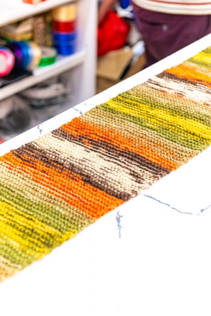 Multicolored woven textile sample displayed on a white work surface