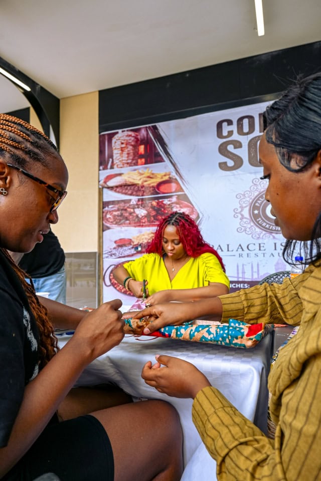 Participants collaborate on a patterned fabric project at the Frame & Fabric Workshop at Galleria