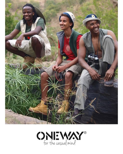 Outdoor promotional image of three men wearing casual clothing with the ONE WAY logo beneath.