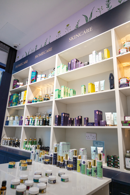 Store interior with white shelves displaying home-care and skincare products