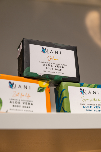 JANI body soap boxes in black, orange, and green packaging displayed on a shelf