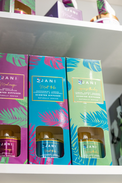 Colorful JANI diffuser gift sets in magenta, blue, and green boxes displayed on a shelf