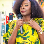 Connie Oluoch speaks into a microphone during Style, Shop & Sip at Galleria Shopping Mall