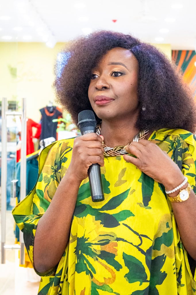 Connie Oluoch speaks into a microphone during Style, Shop & Sip at Galleria Shopping Mall