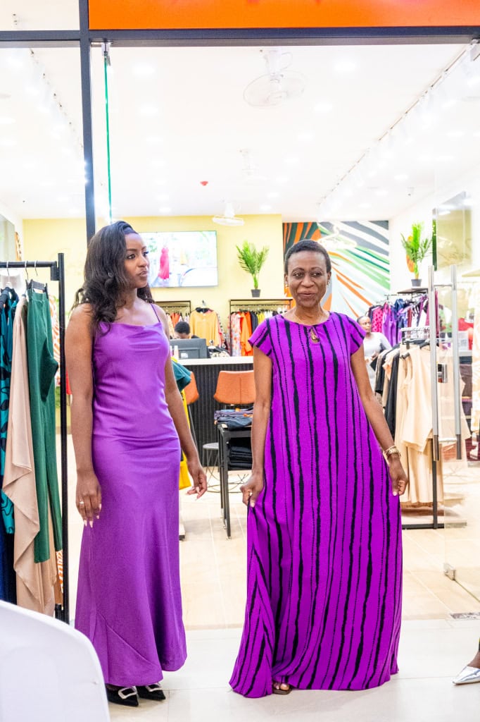 Two guests pose in contrasting purple dresses during Style, Shop & Sip with Connie Oluoch.