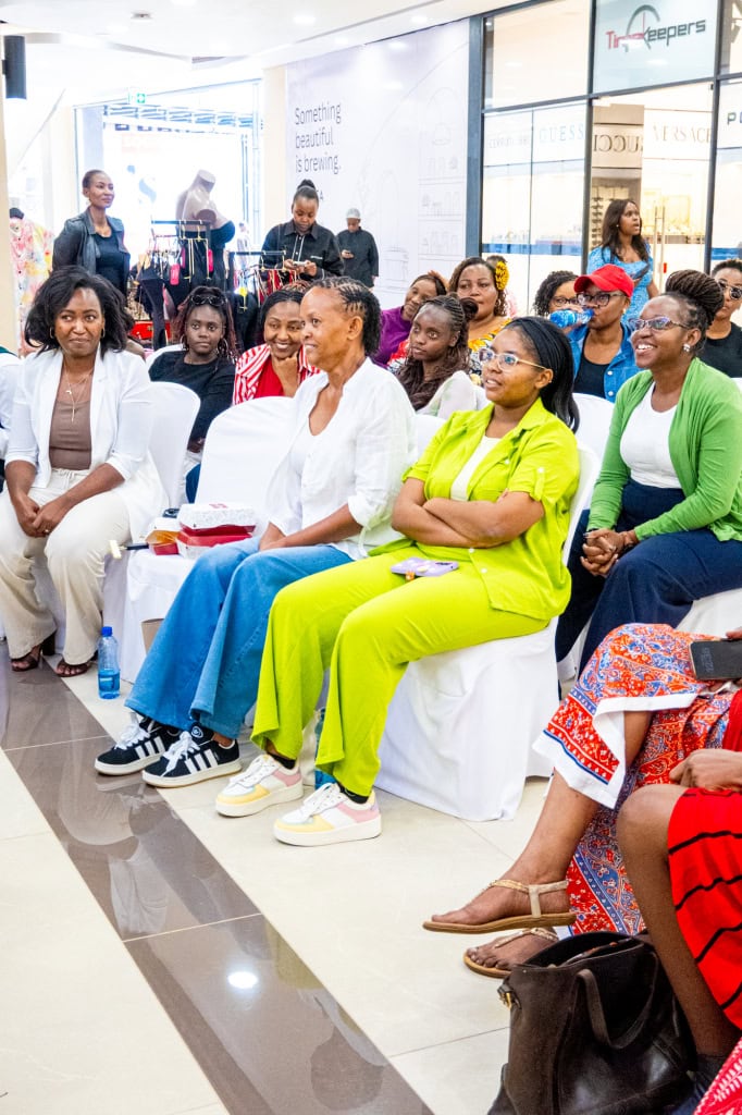 A diverse audience attends Style, Shop & Sip with Connie Oluoch in the shopping mall.