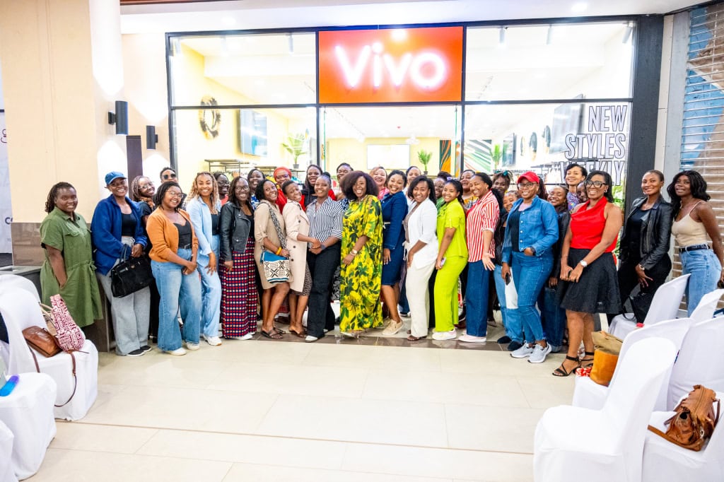 Guests pose together outside the Vivo store during Style, Shop & Sip with Connie Oluoch at Galleria Shopping Mall.