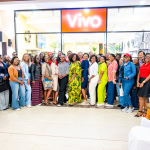 Guests pose together outside the Vivo store during Style, Shop & Sip with Connie Oluoch at Galleria Shopping Mall.