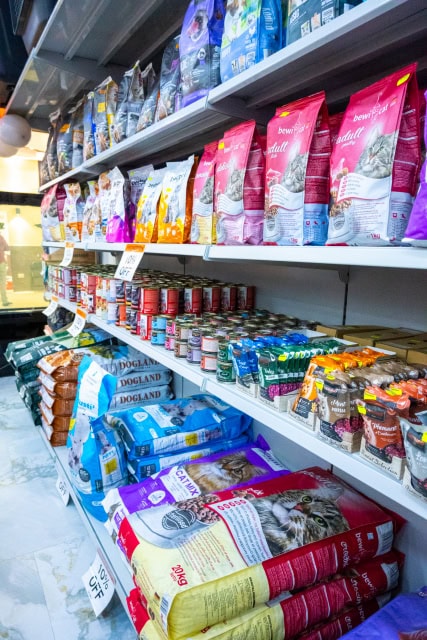 Wide view of retail shelves filled with assorted cat food products