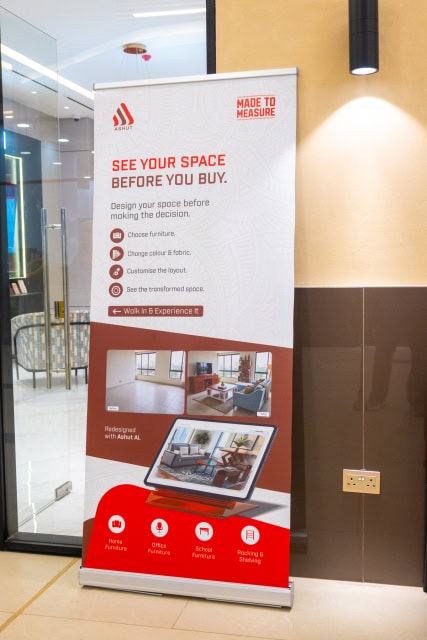 ASHUT promotional banner reading “See Your Space Before You Buy” beside a store entrance.