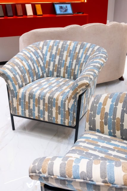 Patterned lounge chairs displayed in a bright showroom.