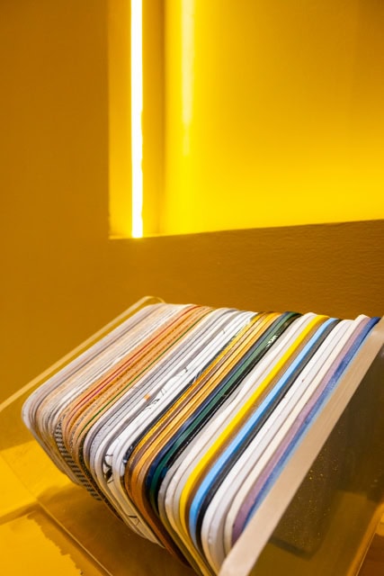 A fan of multicoloured layered material samples arranged on a display shelf