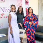 Three Women at Wellness Within Event Three women posing together in front of a Wellness Within event backdrop.