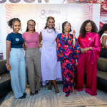 Five-Woman Group Portrait at Wellness Within Event Five women pose together in front of a Galleria Wellness Within event backdrop.