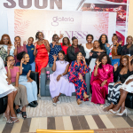 Guests Celebrate Together at the Wellness Event A large group of women pose together in front of a Galleria Wellness event backdrop.
