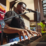 Hands Playing the Keyboard Musician playing a keyboard during a live performance.