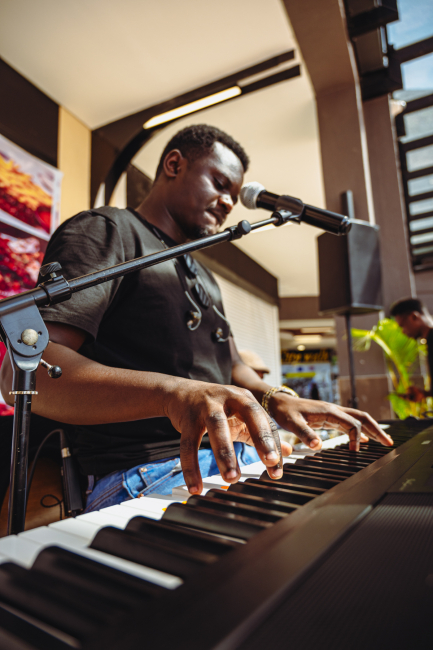 Musician playing a keyboard during a live performance.