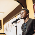 Keyboard Player Singing A musician sings into a microphone while playing a keyboard