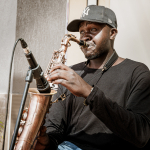 Saxophonist playing beside a microphone during a live performance