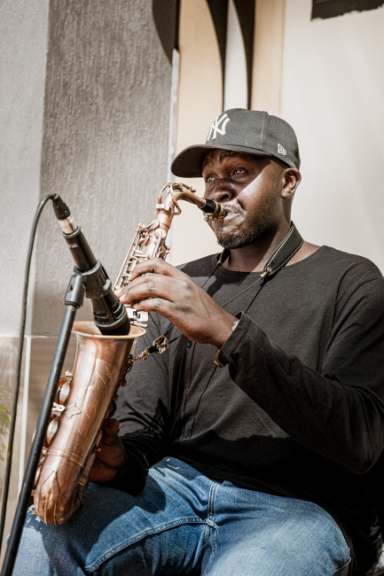Saxophonist playing beside a microphone during a live performance