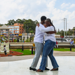 Couple Dancing Across the Plaza Two people dance closely together across an outdoor mall plaza