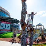 DZ6 1288 Performers form a tall human pyramid outside the shopping mall.