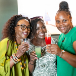DZ6 1605 Three smiling women hold up colorful drinks for the camera