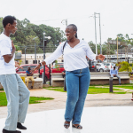 Couple Dancing in the Outdoor Plaza A smiling woman dances with a man on the mall's outdoor plaza
