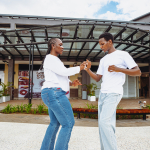 Partners Dancing Hand in Hand A woman and man dance while holding hands in the mall courtyard