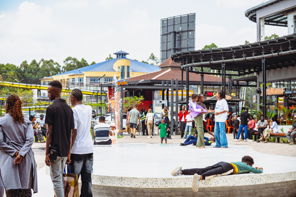 Visitors gather around the mall courtyard while performers entertain the crowd.
