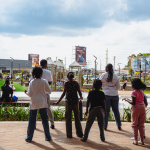 Visitors Viewing the Outdoor Mall Area Five visitors stand on a brick terrace looking across the outdoor mall area.